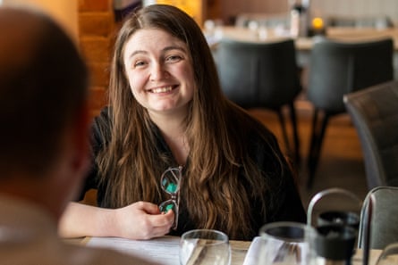 Livvy sitting at a restaurant table