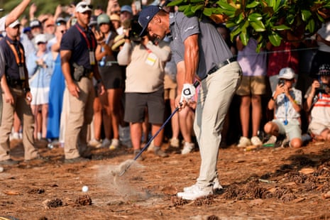 Bryson DeChambeau hits from the native area on the 18th hole.