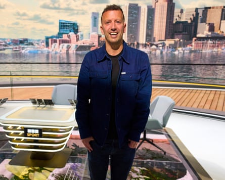 Alex Kay-Jelski stands in front of the BBC Sport desk in a TV studio