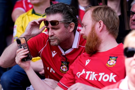 Wrexham fans check on scores from other matches.