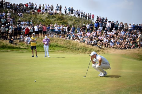 Rory McIlroy of Northern Ireland lines up a putt on the second green