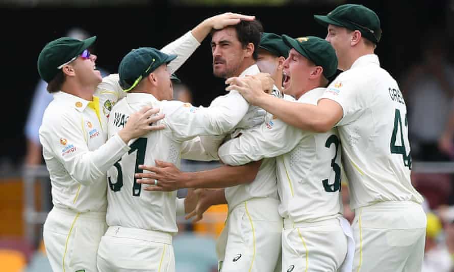 Australia players congratulate Mitchell Starc after taking the wicket of Rory Burns on the first ball of the Ashes series.
