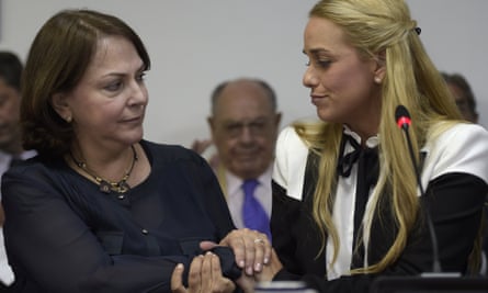 Lilian Tintori and Mitzy Capriles, the wives of Venezuelan opposition leaders Leopoldo López and Antonio Ledezma respectively, hold hands during a meeting with Argentine opposition legislators.