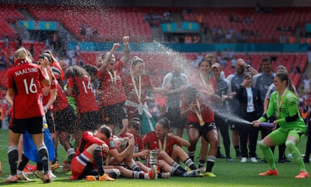 Earps sprays her Manchester United teammates with champagne as they celebrate last seaon’s FA Cup final victory over Tottenham.