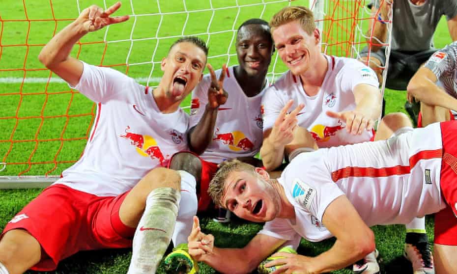 RB Leipzig players celebrate beating Borussia Dortmund in their first ever home Bundesliga match.