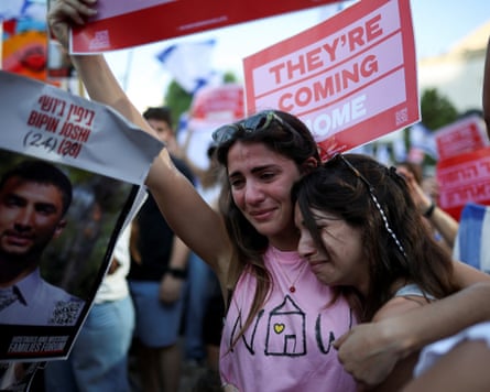 Women react at "Hostages Square" on the day Hamas releases hostages