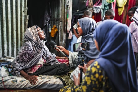 Naima Said Salah interviews a women in a market