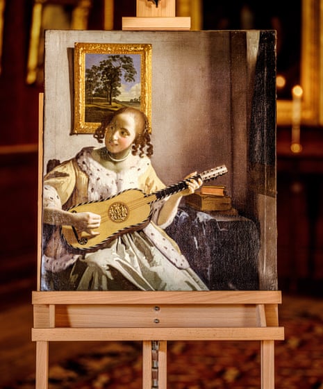 English Heritage conservators inspect The Guitar Player by Johannes Vermeer (c.1672) as it was intended to be seen, by candlelight, for the first time in over 100 years, at Kenwood House in London.