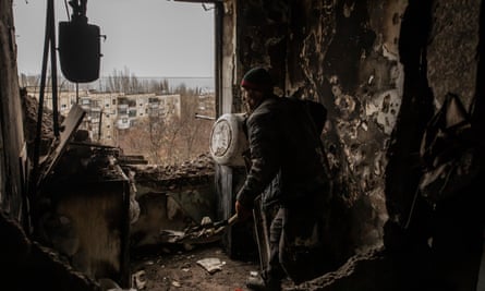 A worker fixes an apartment in a building hit by a Russian missile few days ago in Nikopol.