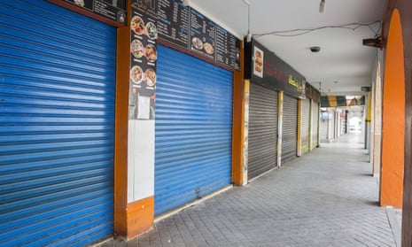 Shutters are drawn down on shops lining a usually busy street in the coastal town of La Marsa, near Tunis