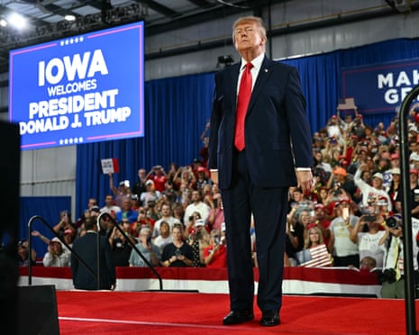 President Trump stands on a red carpet before a cheering crowd at a rally