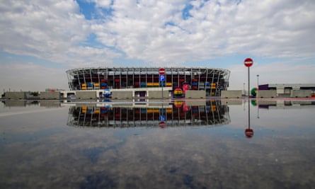 Stadium 974 reflected in rainwater in Doha