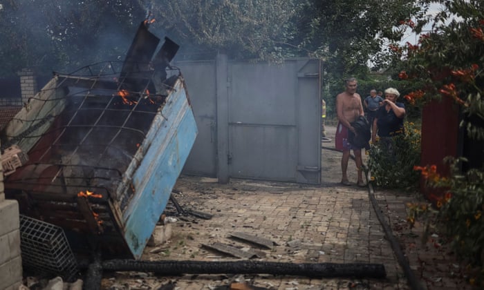 Volodymyr, 64, a local resident in the eastern Ukrainian city of Kostiantynivka, looks at his burning house after a Russian strike on Saturday