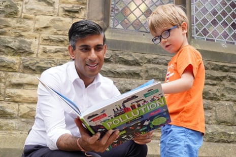 Rishi Sunak looking at a book with Teddy Openshaw (aged 4) following a Conservative leadership campaign event in Ribble Valley today. Teddy was at the event with his dad.