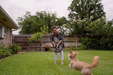 Betsy Lewis, 75, plays with her dog at her home in Houston, Texas.