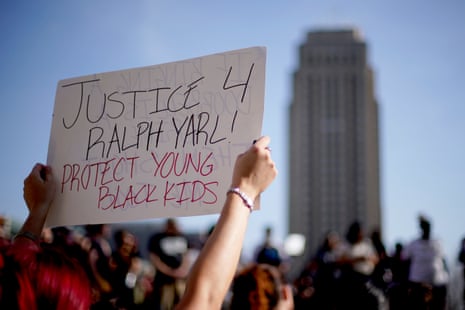 A person holds a sign reading 'Justice 4 Ralph Yarl! Protect young Black kids'.