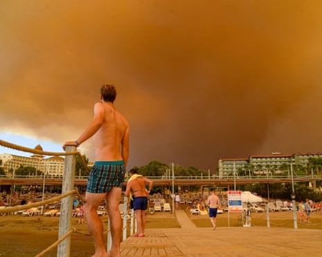 Dark smoke drifts over a hotel complex during a massive forest fire which engulfed a Mediterranean resort region on Turkey's southern coast near the town of Manavgat, Antalya, on July 29, 2021.