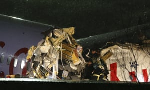 Health teams and fire brigade crews are seen near debris of a passenger plane in Istanbul.