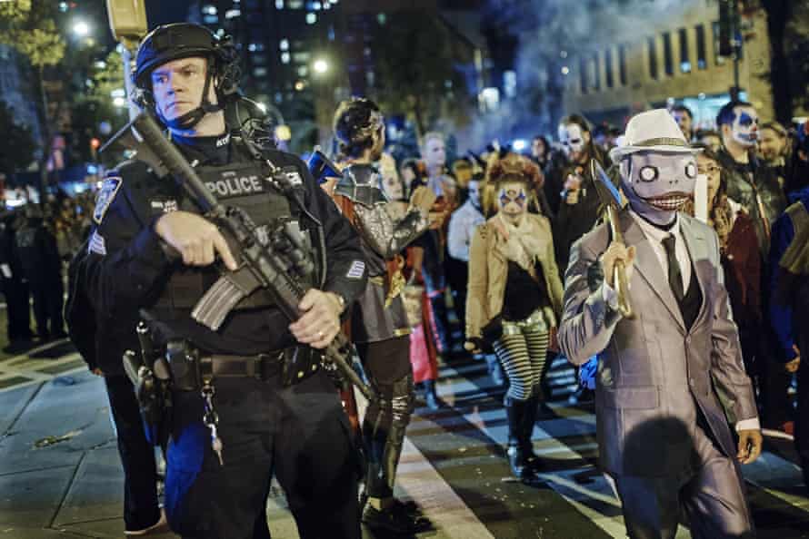 Police guard as revellers march during the Greenwich Village Halloween parade.