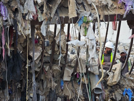 Worker amid rags and stones on a concrete crushing site