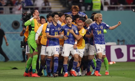 Takuma Asano of Japan celebrates with teammates after scoring their team’s second goal against Germany