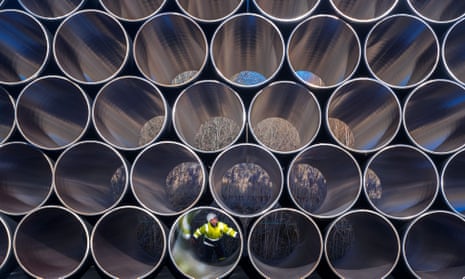 A worker inspects pipes that will be used for the construction of the Nord Stream 2