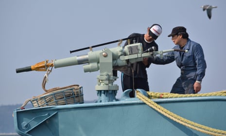 Crew members of a whaling ship check a whaling gun or harpoon before departure at Ayukawa port in Ishinomaki city. 