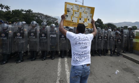 COLOMBIA-VENEZUELA-CRISIS-BORDER<br>Venezuelan national policemen clash with demonstrators at the Simon Bolivar international bridge, in Cucuta, Colombia after President Nicolas Maduro’s government ordered to temporary close down the border with Colombia on February 23, 2019. - Venezuela braced for a showdown between the military and regime opponents at the Colombian border on Saturday, when self-declared acting president Juan Guaido has vowed humanitarian aid would enter his country despite a blockade. (Photo by Luis ROBAYO / AFP)LUIS ROBAYO/AFP/Getty Images