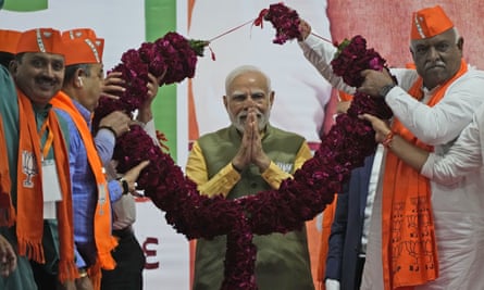Narendra Modi receives a garland as he campaigns during the Gujarat state legislature elections last year.