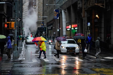 People walk under umbrellas during a coastal storm in Lower Manhattan on September 29, 2023 in New York City.