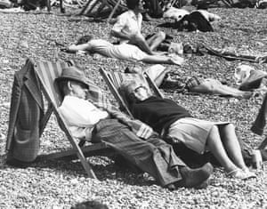 A relaxed bank holiday Monday on Brighton beach, August 1980. An older couple asleep in deckchairs. GNM Archive ref: GUA/6/9/1/1/H