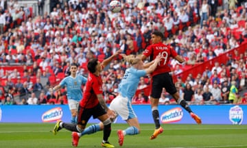Erling Haaland of Manchester City falls after a challenge by Lisandro Martinez of Manchester United in the penalty area during the Emirates FA Cup Final match between Manchester City and Manchester United at Wembley Stadium on 25 May 2024.