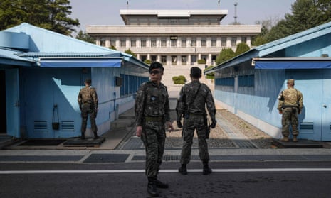 South Korean soldiers standing guard outside a meeting hut in the truce village of Panmunjom within the Demilitarized Zone.