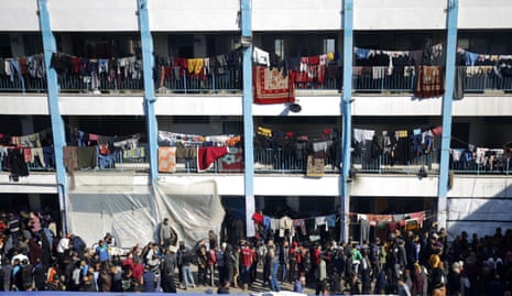 Palestinian families who lost their homes take shelter at a United Nations Relief and Works Agency for Palestine Refugees in the Near East (UNRWA) school in Deir al-Balah, Gaza.