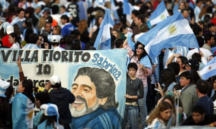 A fan holds a banner bearing a drawing of Diego Maradona in Buenos Aires, the city of his birth, in July 2010 following an Argentina game under their legendary No 10 at the 2010 World Cup in South Africa.