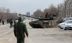 Russian servicemen seen atop of a tank on the outskirts of the besieged southern port city of Mariupol, Ukraine