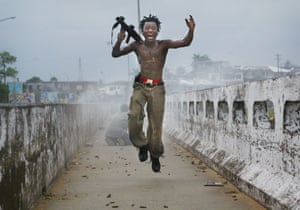 Monrovia, 2003A Liberian militia commander loyal to the government, exults after firing a rocket-propelled grenade at rebel forces at a key strategic bridge July 20, 2003
