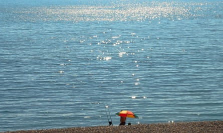 A man fishes from Chesil beach in Dorset on Sunday.