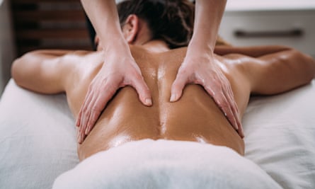 Back Sports Massage TherapyPhysiotherapist massaging female patient with injured lower back muscle.  Sports injury treatment.
