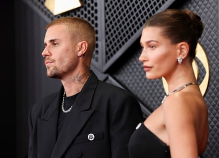 Justin and Hailey Bieber wear ‘ICE out’ pins on the red carpet at the Grammy awards.