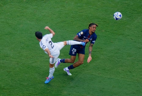 Paris St Germain's Bradley Barcola is kicked by Real Madrid's Dani Carvajal which earns him a booking.