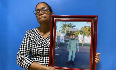 Nomeia Pereira dos Santos holds up a framed photograph mother of her son Maxciel Pereira dos SantosPereira dos Santos, a an officer in Brazil's Funai indigenous agency,
who was shot dead in the city of Tabatinga in September 2019