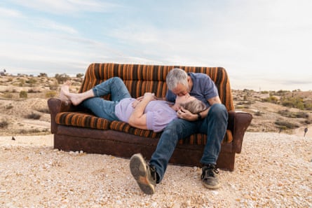 Tallon Towers, 66, and Liz Welsh, 59, sit on their outdoor couch