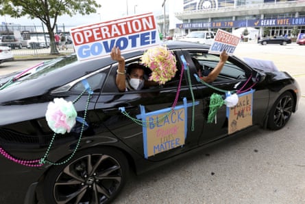 Activists drive past an early voting location at the end of a Parade to the Polls event on 3 November in New Orleans.