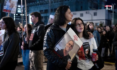 Women listen to a speaker during a rally calling for the release of hostages