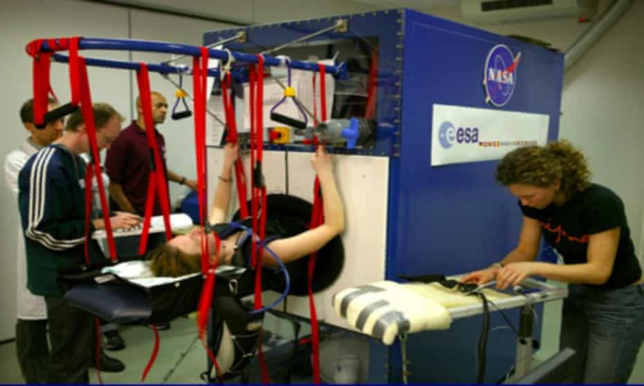 The large Hoover-like device seals around the astronaut’s waist, creating the impression of weight on the lower body through a powerful suction force.