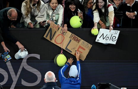 Novak Djokovic signs autographs with fans after winning his third round match against Tomas Martin Etcheverry.