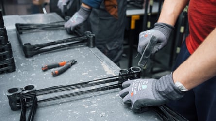 Workers at a Fire Point factory in Ukraine making drones, hands only visible.