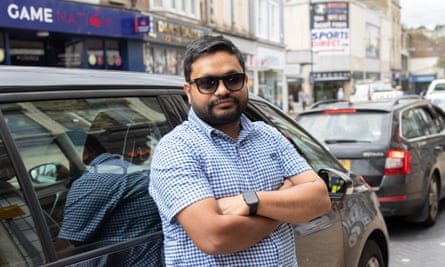 Anik standing beside his car