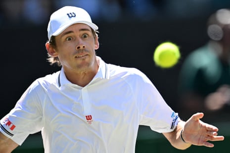 Alex De Minaur looks at the ball